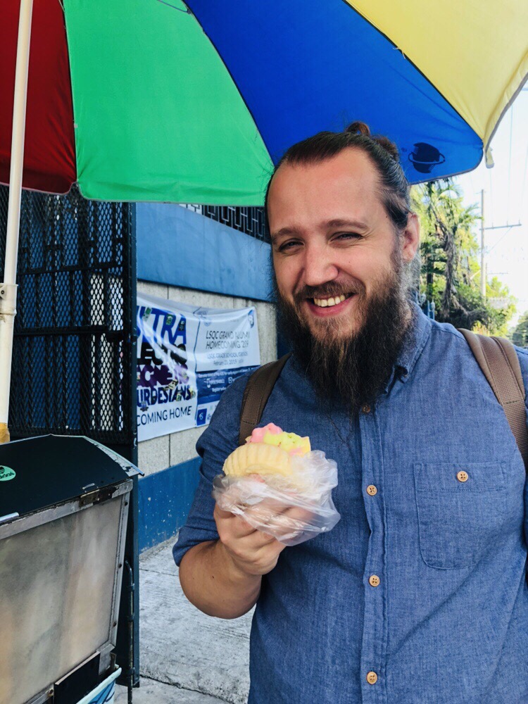 Matias smiling with ice cream in bread.